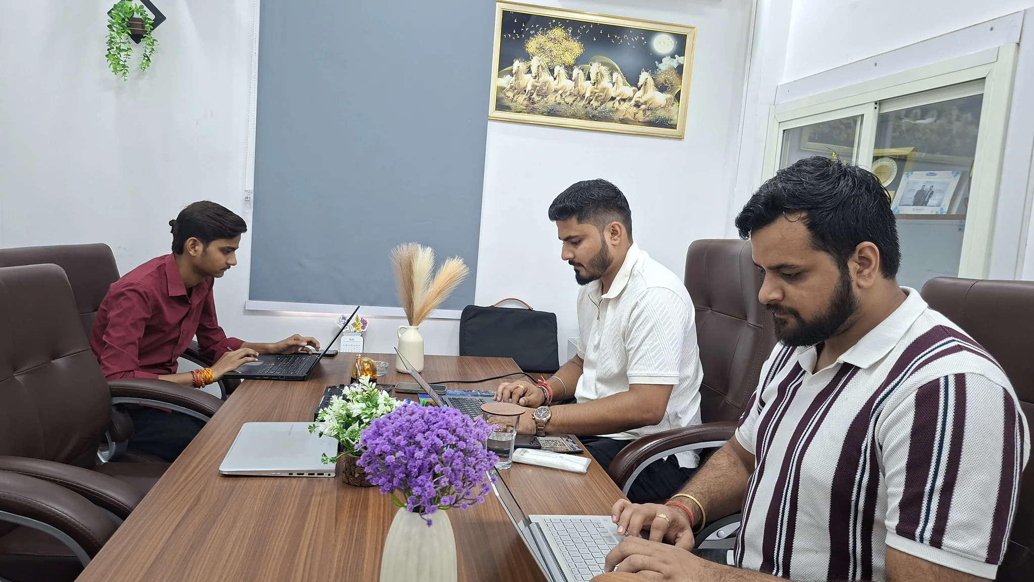 ARUNASUN team working together around an office table