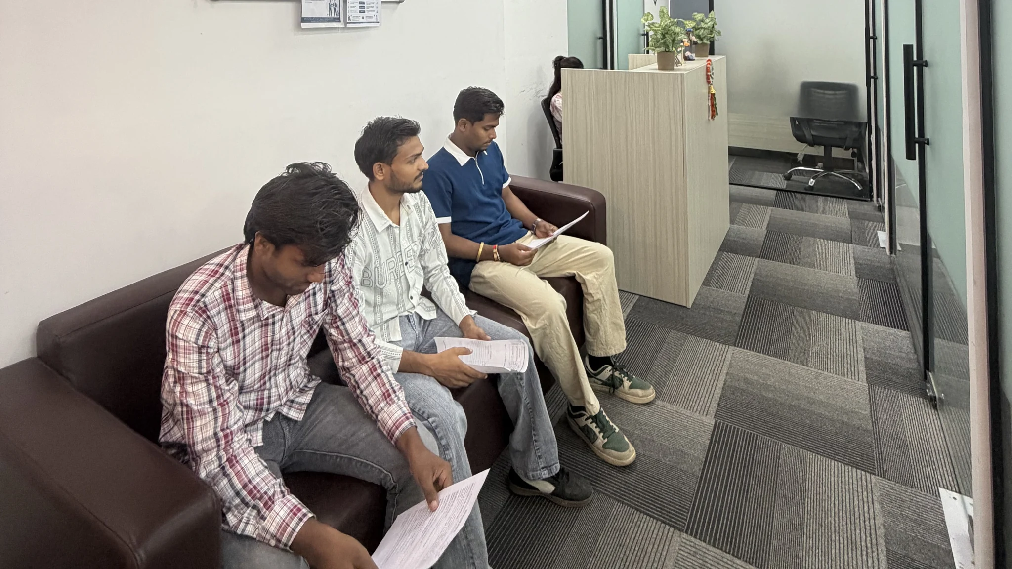Visitors seated in the office waiting area