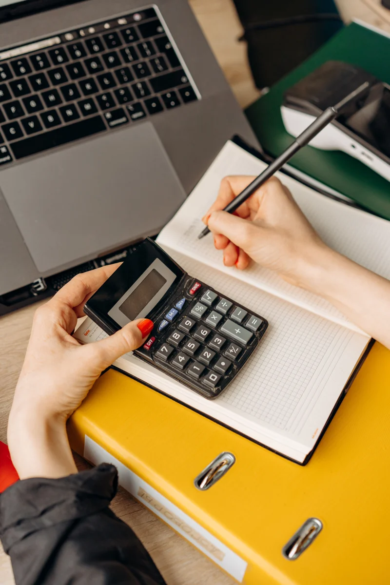 Using a calculator and notebook to plan a budget